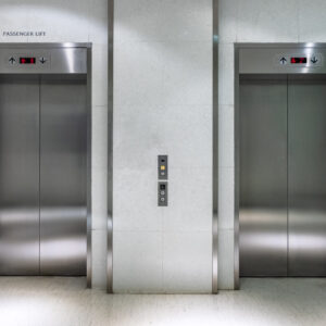 Metallic elevator two gate closed of passenger lift at lobby