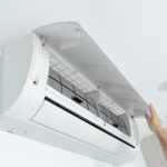 The guy cleans the filter of the home air conditioner from dust. Very dirty air conditioner filter. Climate equipment care. Laudo Técnico Ar Condicionado e PMOC