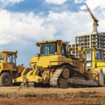 Bulldozer machine is leveling construction site. Earthmover with sky background. close-up. construction heavy machinery. Laudo Técnico Máquinas Pesadas
