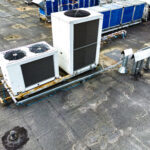 Ventilation and air conditioning system on the roof of an office or industrial building. View from above. Air cleaning. Drone photography. Laudo Técnico Ar Condicionado e PMOC